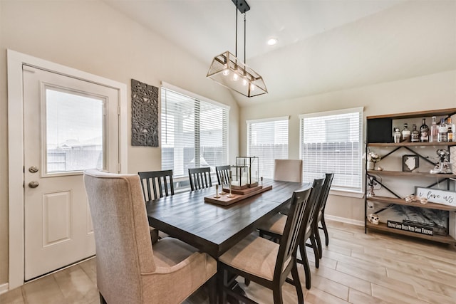 4711 Bartagrass Dr, Rosenberg, TX 77469 - dining area featuring baseboards, light wood-type flooring, and lofted ceiling