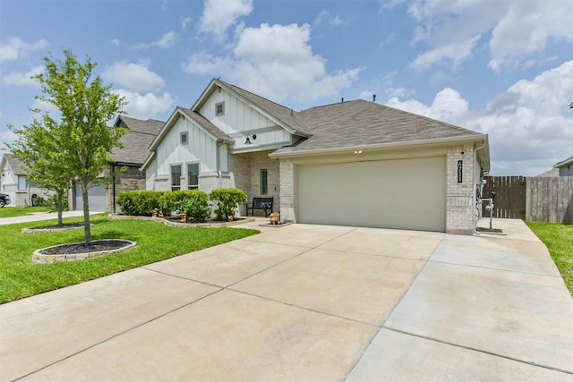 4711 Bartagrass Dr, Rosenberg, TX 77469 - view of front of property featuring fence, a front lawn, brick siding, a garage, and board and batten siding