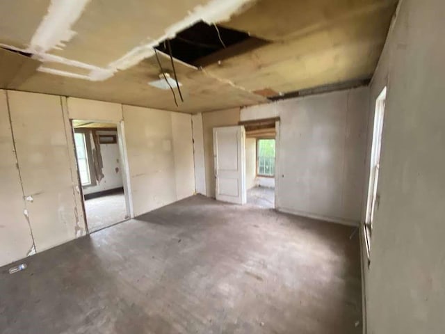 unfurnished room featuring unfinished concrete flooring