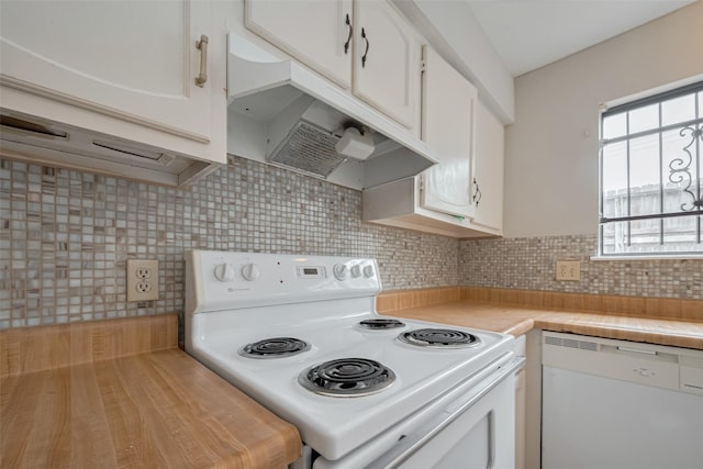 kitchen with light countertops, under cabinet range hood, white cabinets, and white appliances