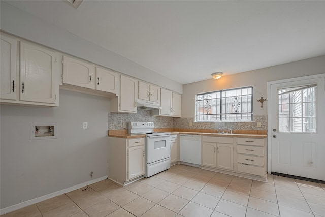 kitchen with light tile patterned floors, tasteful backsplash, under cabinet range hood, and white appliances