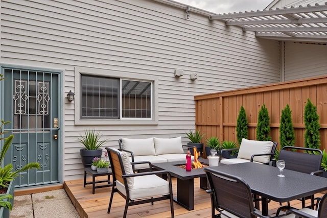 deck with an outdoor living space with a fire pit and a pergola