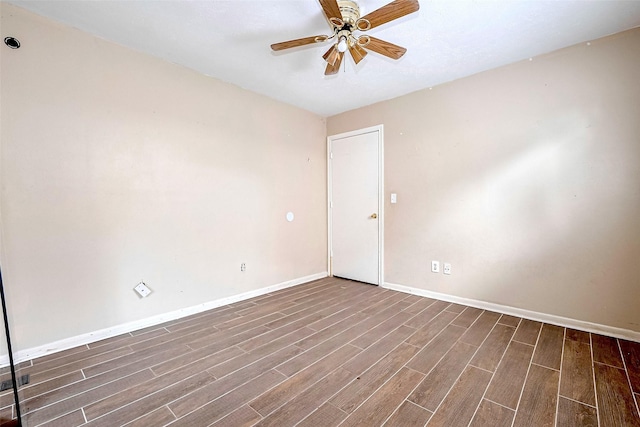 spare room with a ceiling fan, baseboards, and wood finished floors