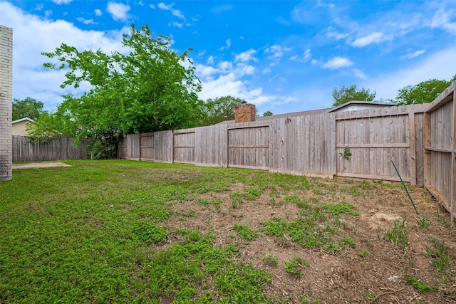 view of yard with a fenced backyard