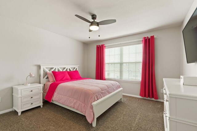bedroom with dark carpet, a ceiling fan, and baseboards