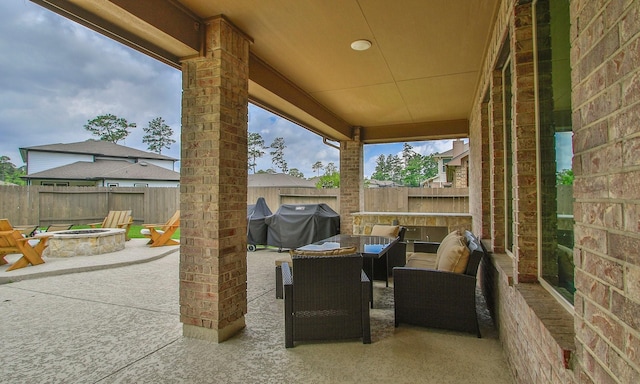 view of patio featuring a fenced backyard, an outdoor fire pit, and a grill