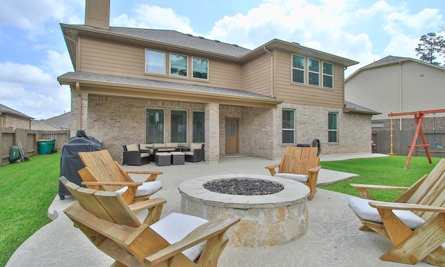 rear view of house featuring brick siding, a patio, a fenced backyard, and an outdoor living space with a fire pit