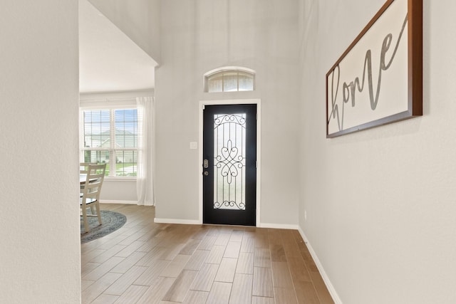 entrance foyer featuring baseboards and wood tiled floor