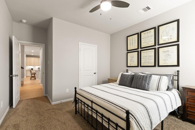 bedroom featuring a ceiling fan, baseboards, visible vents, and light carpet