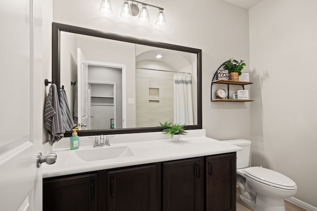 full bathroom with vanity, a shower with shower curtain, and toilet