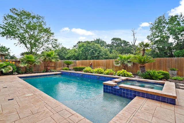 view of pool with a patio, a fenced backyard, and a pool with connected hot tub