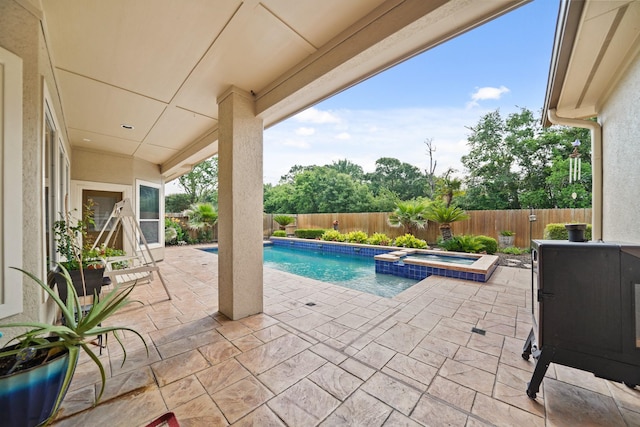 view of swimming pool featuring a patio, a pool with connected hot tub, and a fenced backyard
