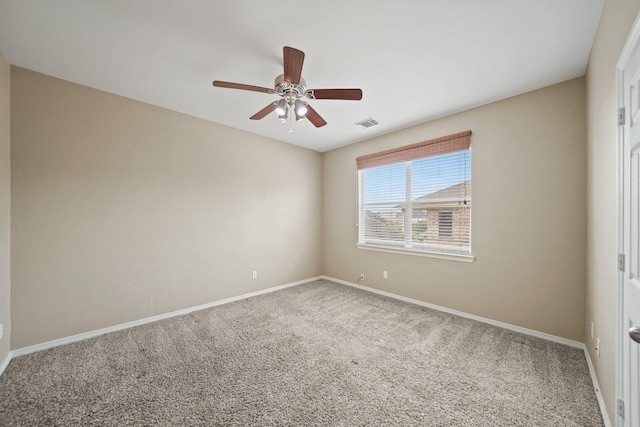 carpeted empty room featuring baseboards, a ceiling fan, and visible vents
