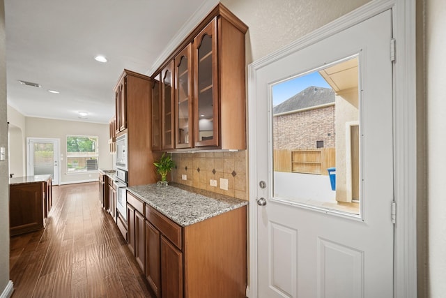 interior space featuring visible vents, crown molding, baseboards, dark wood-style floors, and recessed lighting