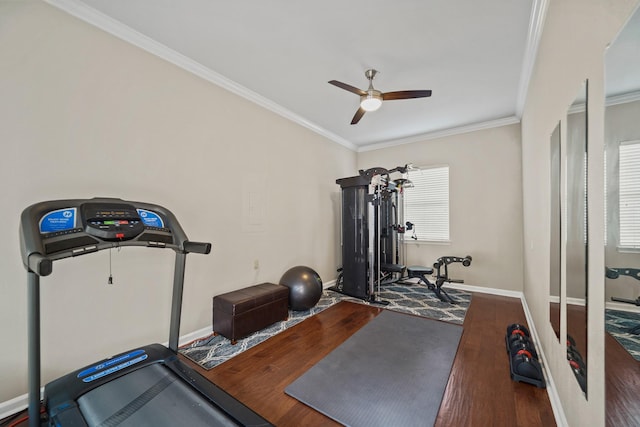 workout area featuring crown molding, a ceiling fan, baseboards, and wood finished floors