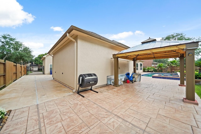 exterior space featuring a gazebo, a fenced in pool, a gate, and a fenced backyard