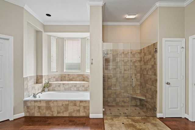 full bathroom with crown molding, a stall shower, a bath, and wood finished floors