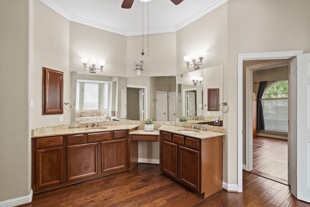 full bath with wood finished floors, ornamental molding, a high ceiling, and vanity