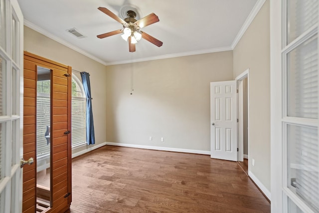 spare room featuring crown molding, ceiling fan, french doors, and wood finished floors