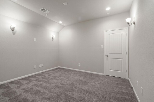 carpeted spare room with recessed lighting, baseboards, vaulted ceiling, and visible vents