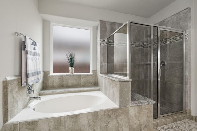 full bath with a bath and a shower stall