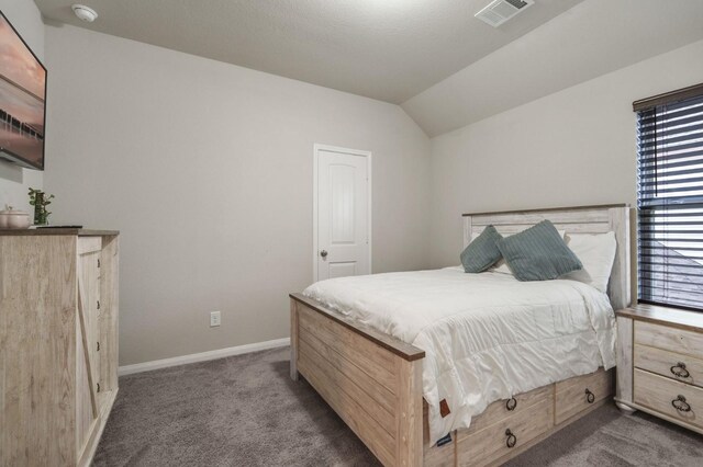 bedroom with visible vents, baseboards, carpet, and lofted ceiling