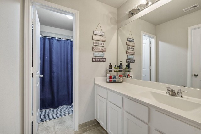 bathroom with a shower with curtain, visible vents, tile patterned flooring, and vanity