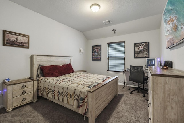 bedroom with dark carpet, visible vents, and vaulted ceiling