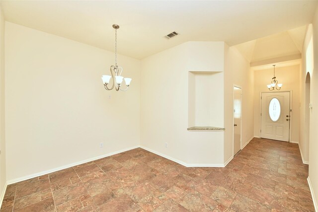 entryway with visible vents, baseboards, a notable chandelier, and stone finish floor
