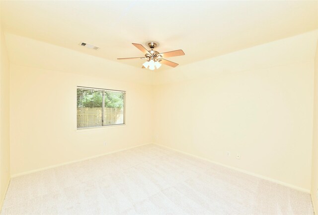 unfurnished room featuring visible vents, baseboards, ceiling fan, and light carpet