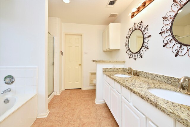 bathroom featuring a sink, tile patterned floors, a bath, and visible vents