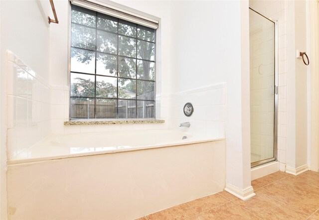full bathroom with a garden tub, tile patterned flooring, and a stall shower