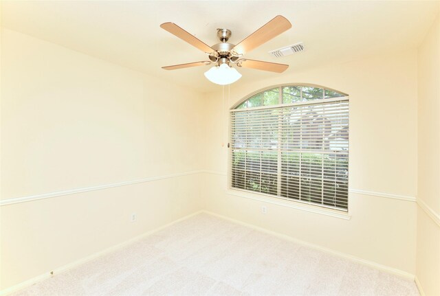 unfurnished room with carpet flooring, baseboards, visible vents, and ceiling fan
