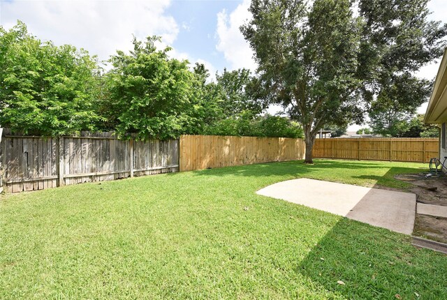 view of yard with a fenced backyard and a patio area