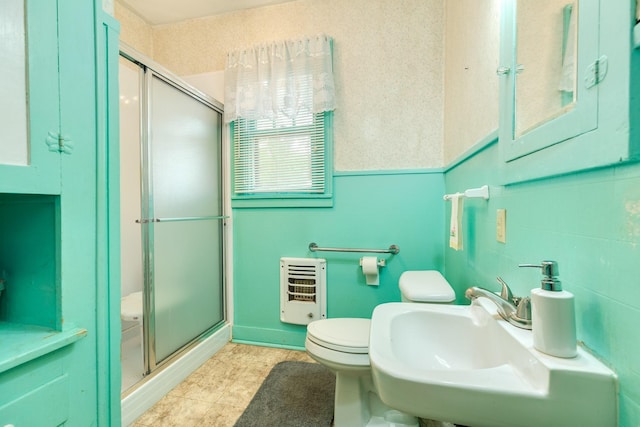202 10th Ave N, Texas City, TX 77590 - bathroom with heating unit, a shower stall, toilet, and a sink