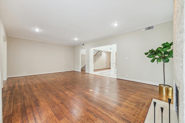 7924 Woodway Dr, Houston, TX 77063 - spare room featuring crown molding, recessed lighting, wood finished floors, visible vents, and stairway