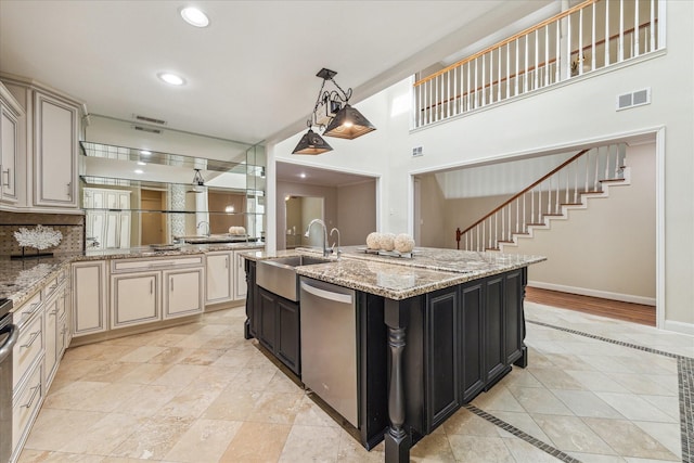 7924 Woodway Dr, Houston, TX 77063 - kitchen featuring stainless steel dishwasher, visible vents, cream cabinetry, dark cabinets, and a sink