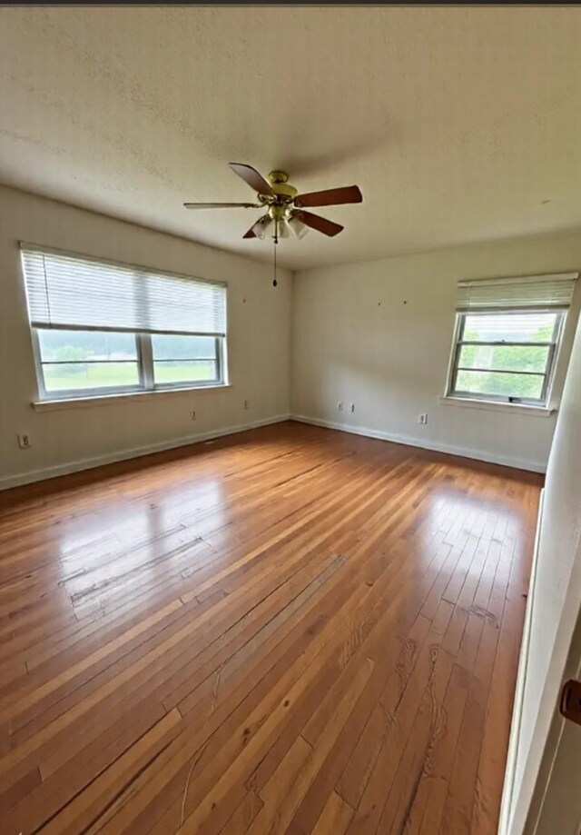 1904 Gun And Rod Rd, Brenham, TX 77833 - unfurnished room with plenty of natural light, hardwood / wood-style flooring, and baseboards