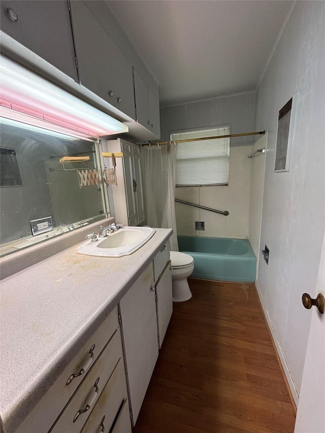 full bathroom featuring toilet, shower / bathtub combination with curtain, wood finished floors, and vanity