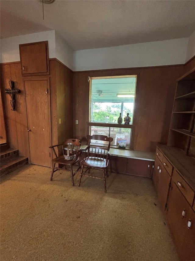dining room featuring wood walls