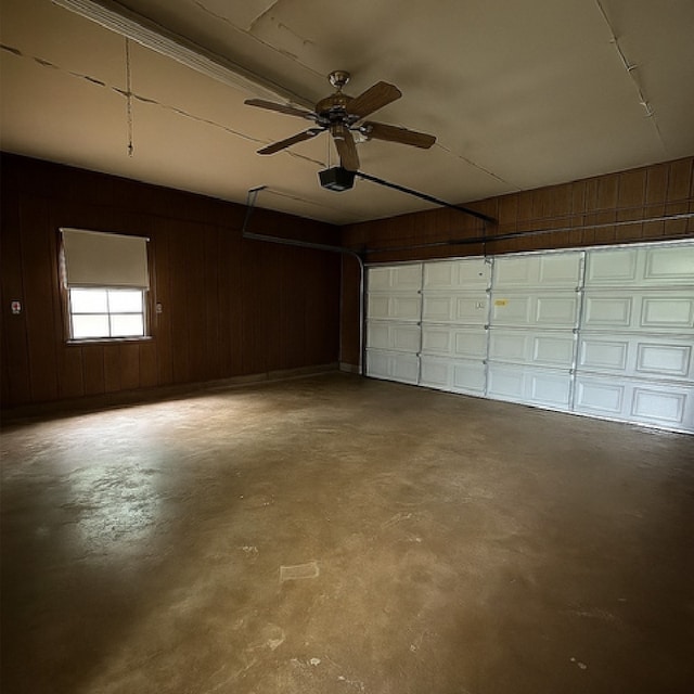 1904 Gun And Rod Rd, Brenham, TX 77833 - garage featuring a garage door opener, wood walls, and ceiling fan