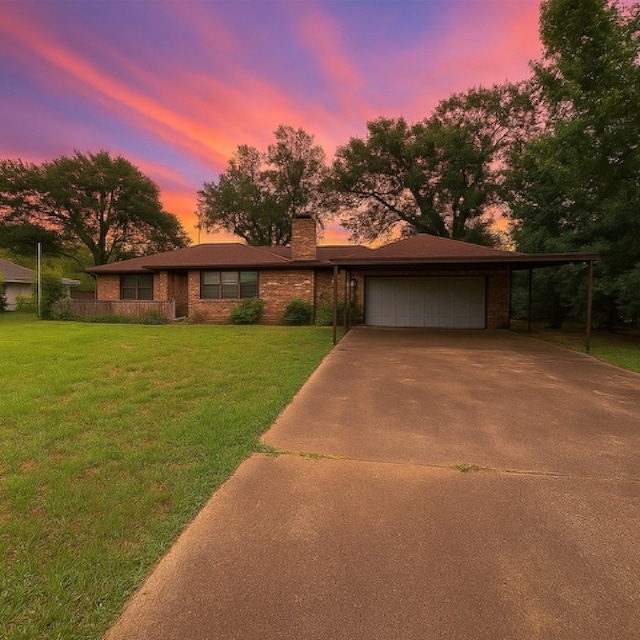 1904 Gun And Rod Rd, Brenham, TX 77833 - view of front facade with a garage, concrete driveway, a chimney, brick siding, and a yard