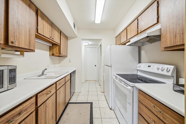 16111 Aspenglenn Dr Unit 404, Houston, TX 77084 - kitchen featuring a sink, light countertops, stainless steel appliances, and under cabinet range hood