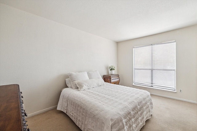 16111 Aspenglenn Dr Unit 404, Houston, TX 77084 - bedroom featuring baseboards and light colored carpet