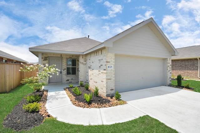 ranch-style house featuring fence, an attached garage, concrete driveway, and brick siding