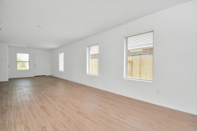 interior space with baseboards and light wood-style flooring