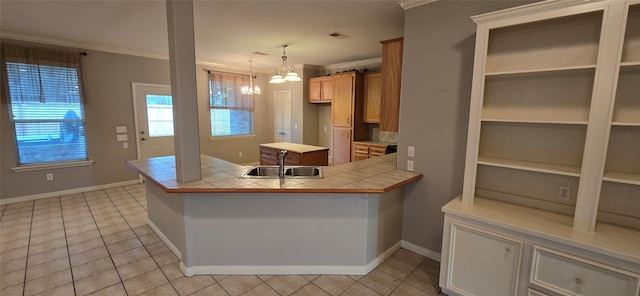 kitchen with crown molding, a peninsula, tile counters, a sink, and light tile patterned floors