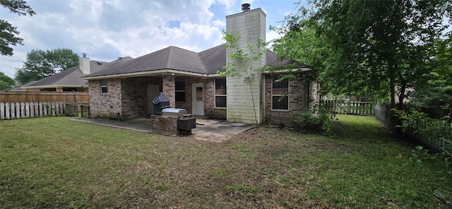 back of house with brick siding, a fenced backyard, a patio area, and a lawn