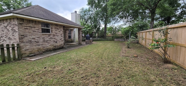 view of yard featuring a patio and a fenced backyard