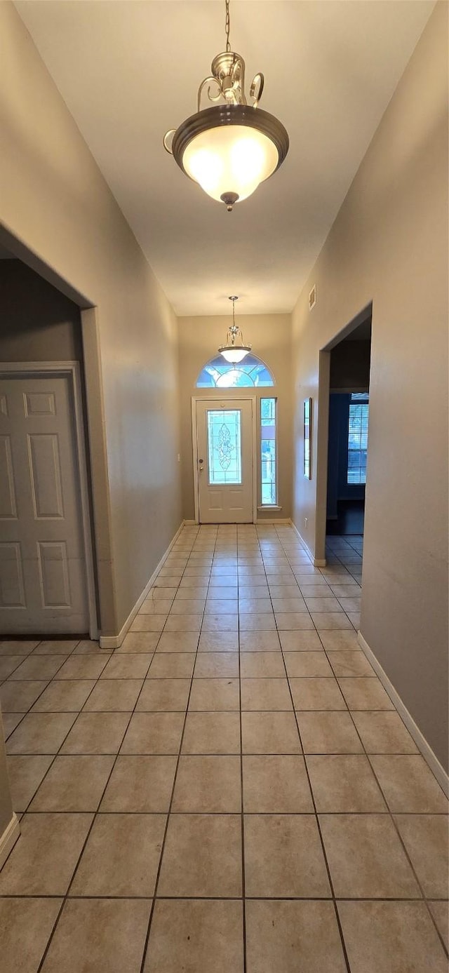 entryway featuring light tile patterned flooring and baseboards